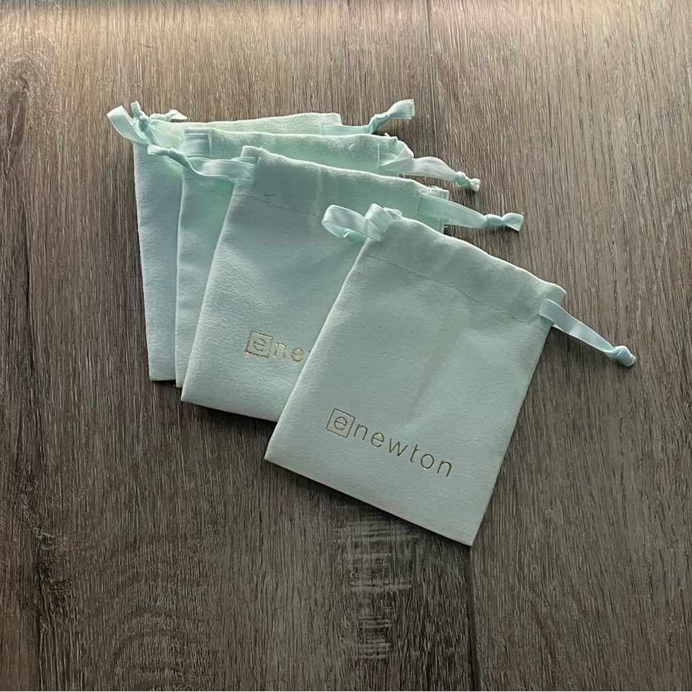 Set of four Enewton authentic jewelry bags